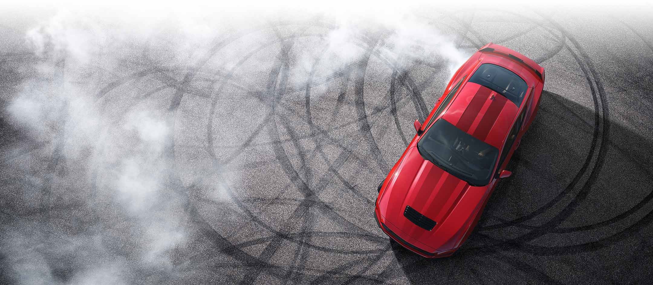 Overhead view of a 2024 Ford Mustang® model with tire tracks on pavement | Sarchione Ford of Randolph in Randolph OH
