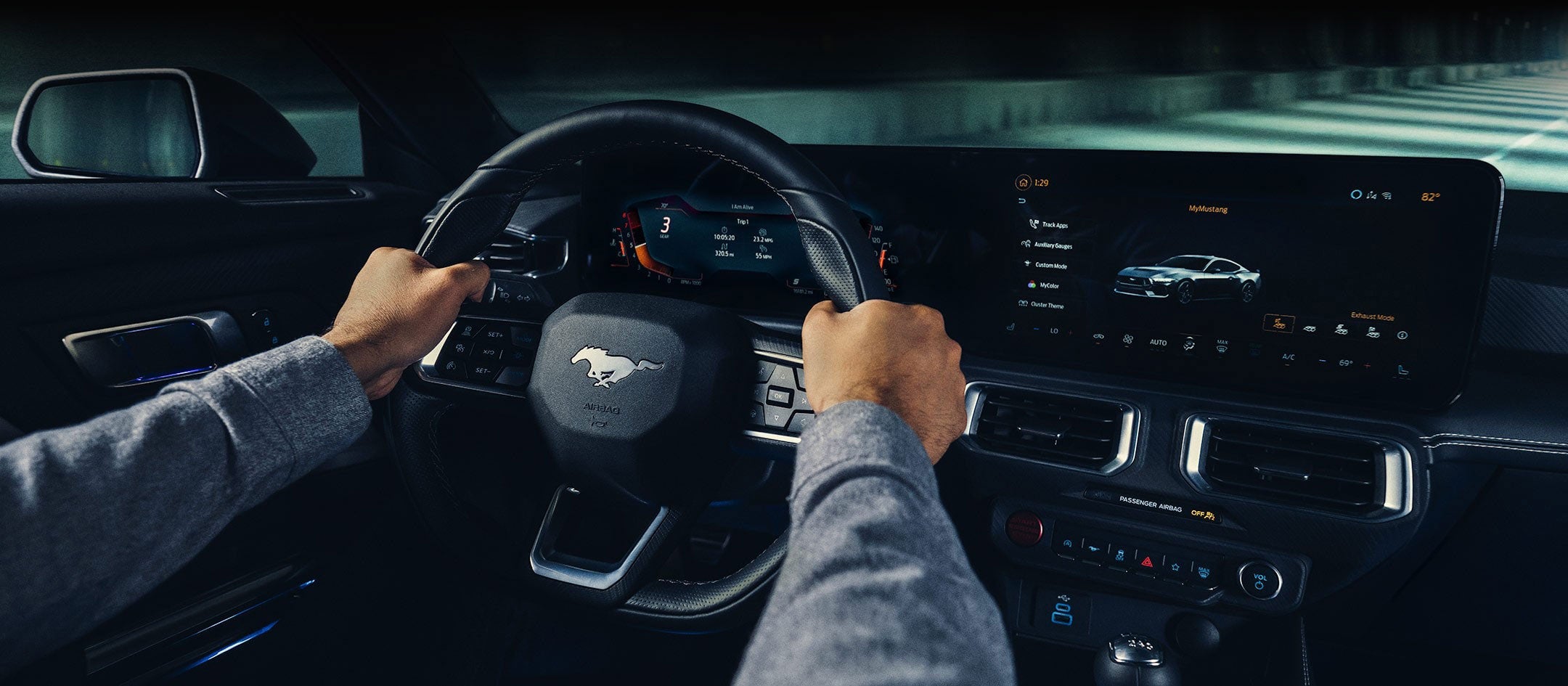A 2024 Ford Mustang® model interior with a person driving | Sarchione Ford of Randolph in Randolph OH